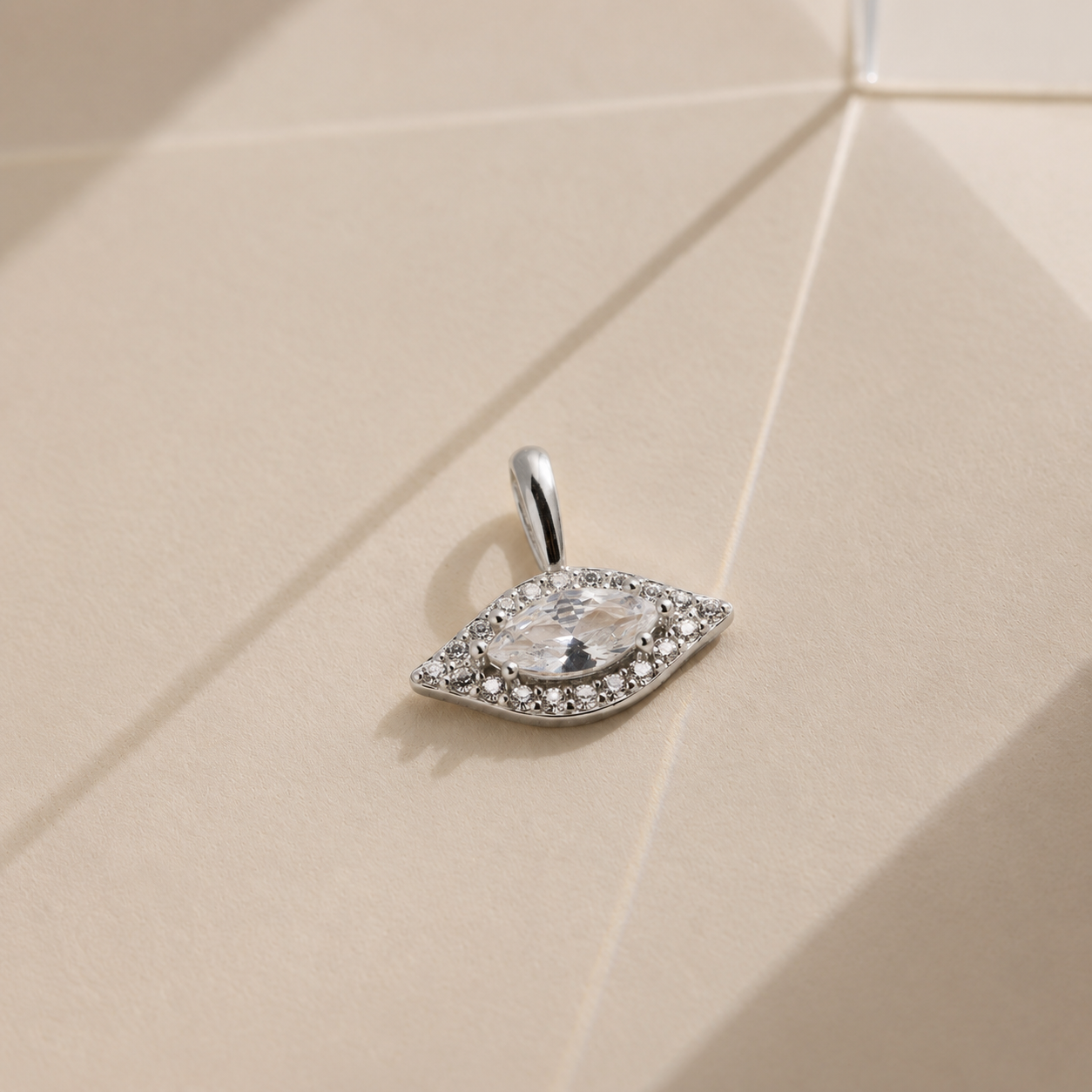 Diamond pendant on a beige textured surface