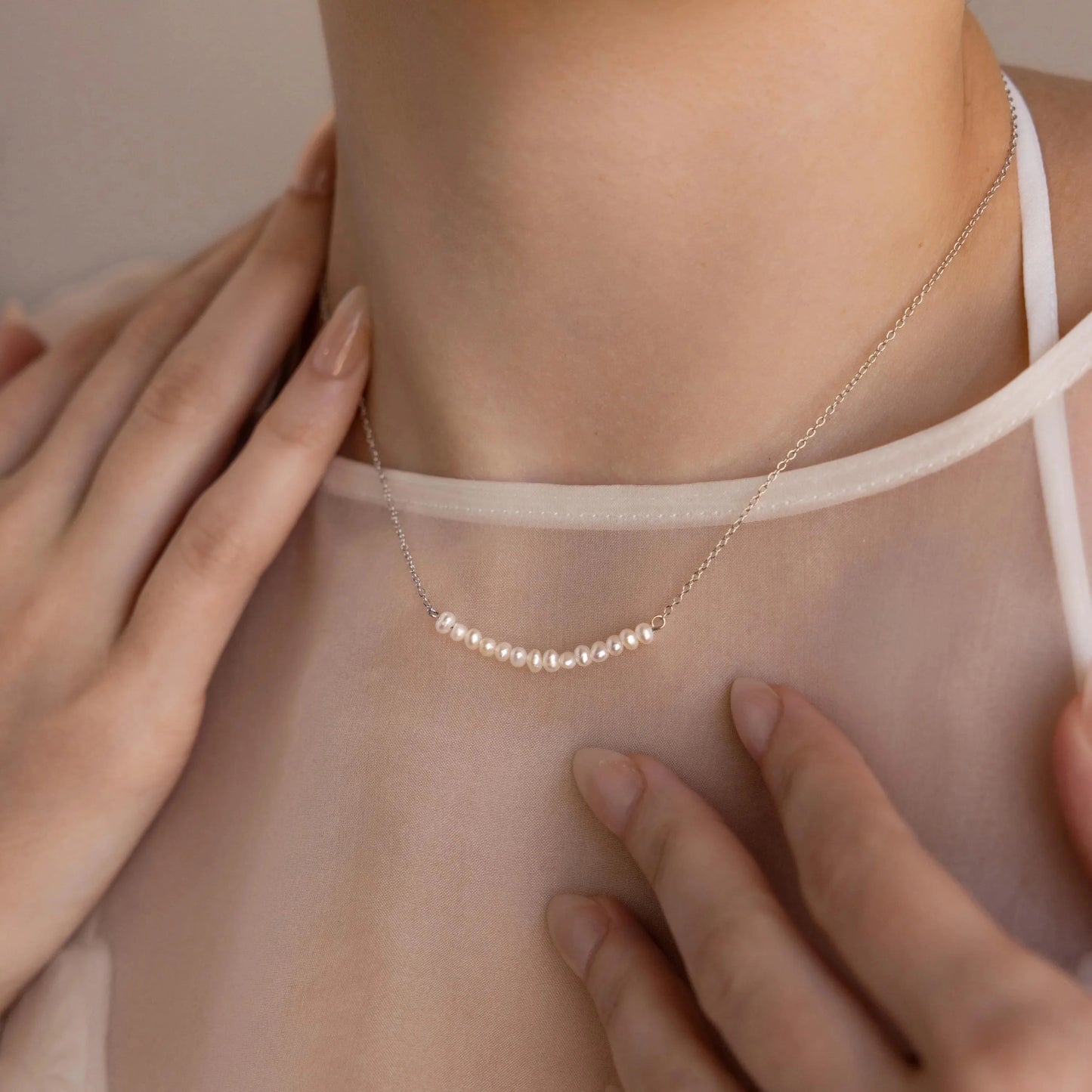 Luxury curved necklace adorned with evenly spaced pearls for an elegant, timeless look.
