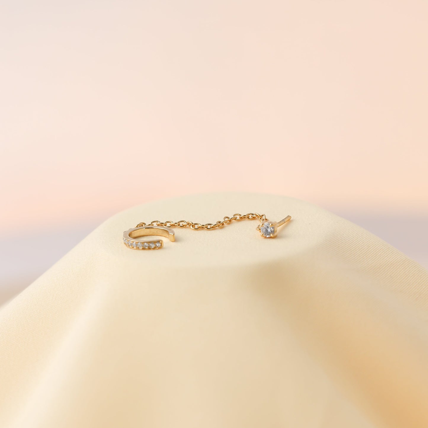 Close-up of sparkling chain ear cuff on ear