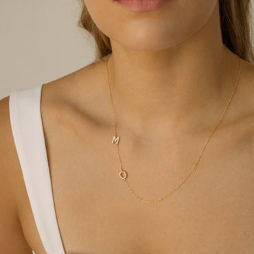 Close-up of pave crystal initial necklace