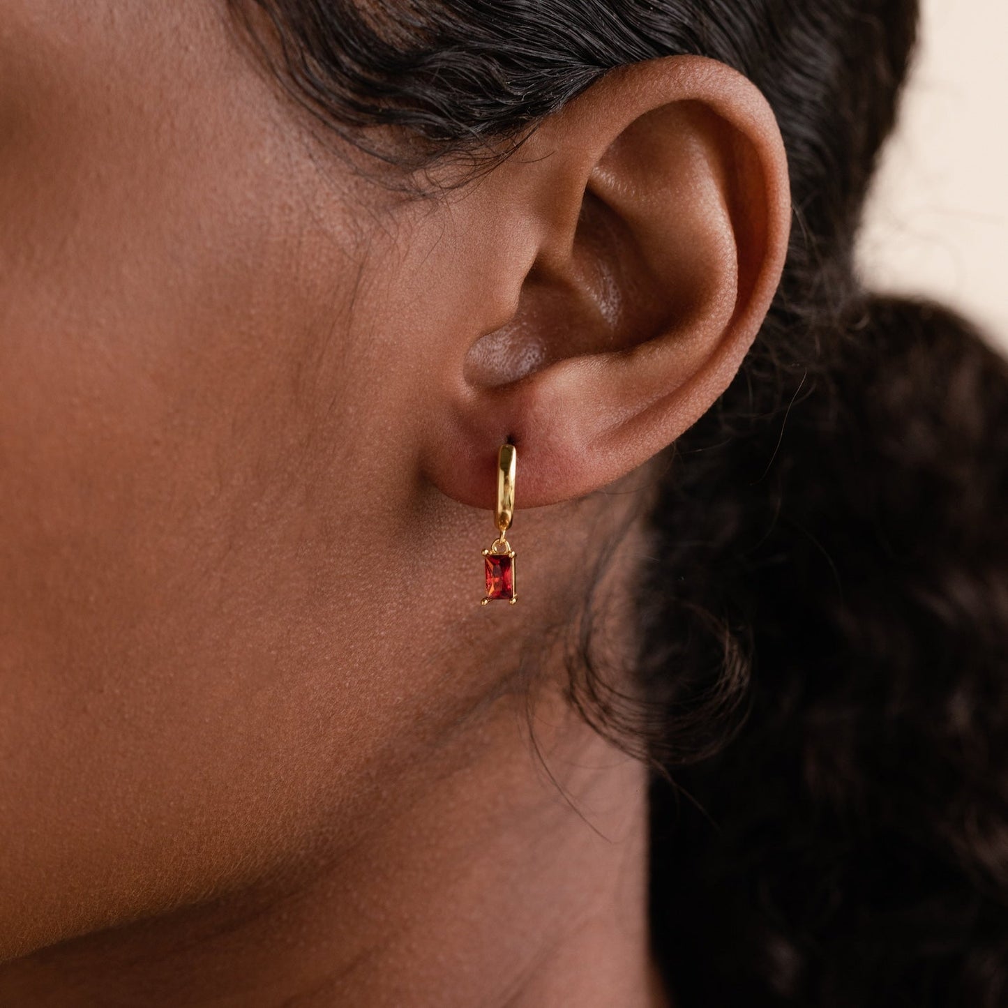 Subtle Birthstone Sparkle: Baguette Birthstone Huggie Hoops 18K Gold January Garnet