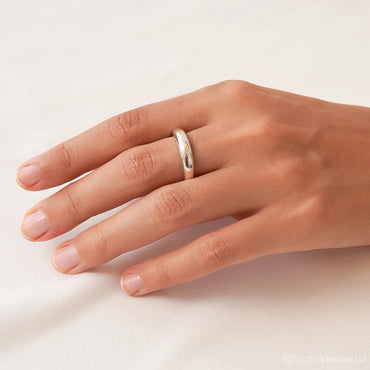 A simple yet elegant dome ring made of 925 sterling silver, shown on a person's hand.