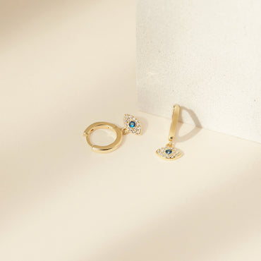 Gold huggie earrings with sparkling CZ stones.