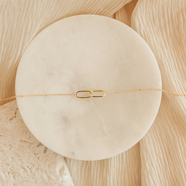 Minimalist linked pendant on chain.