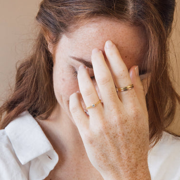 A person with a 3mm genuine CZ gemstone ring on their finger, which is wearing a curb chain detail.