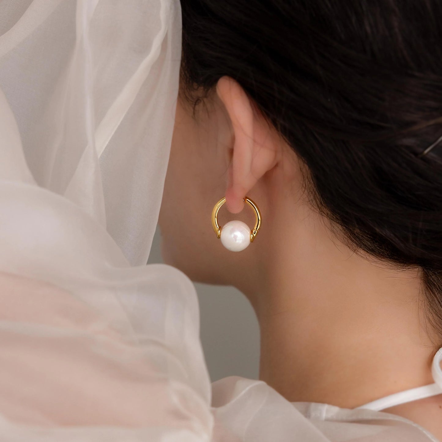 Statement pearl hoop earrings for elegant style.