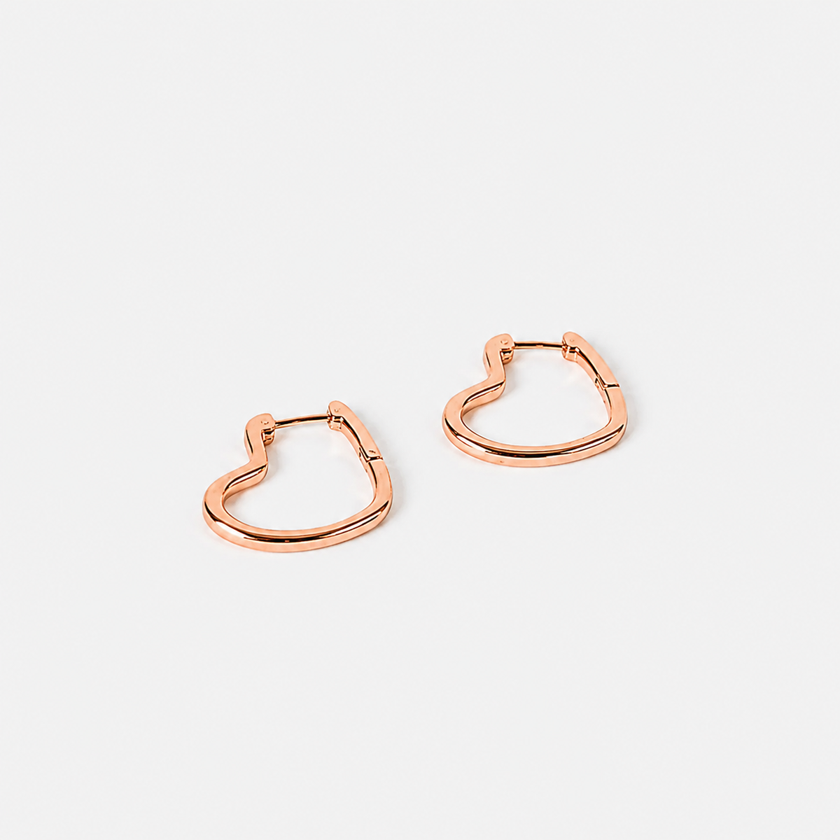 Rose gold hoop earrings on a light gray background
