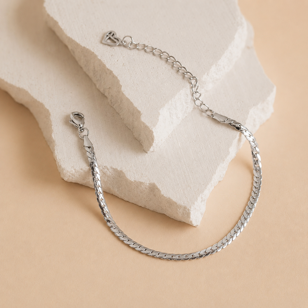 Silver bracelet on a textured beige surface