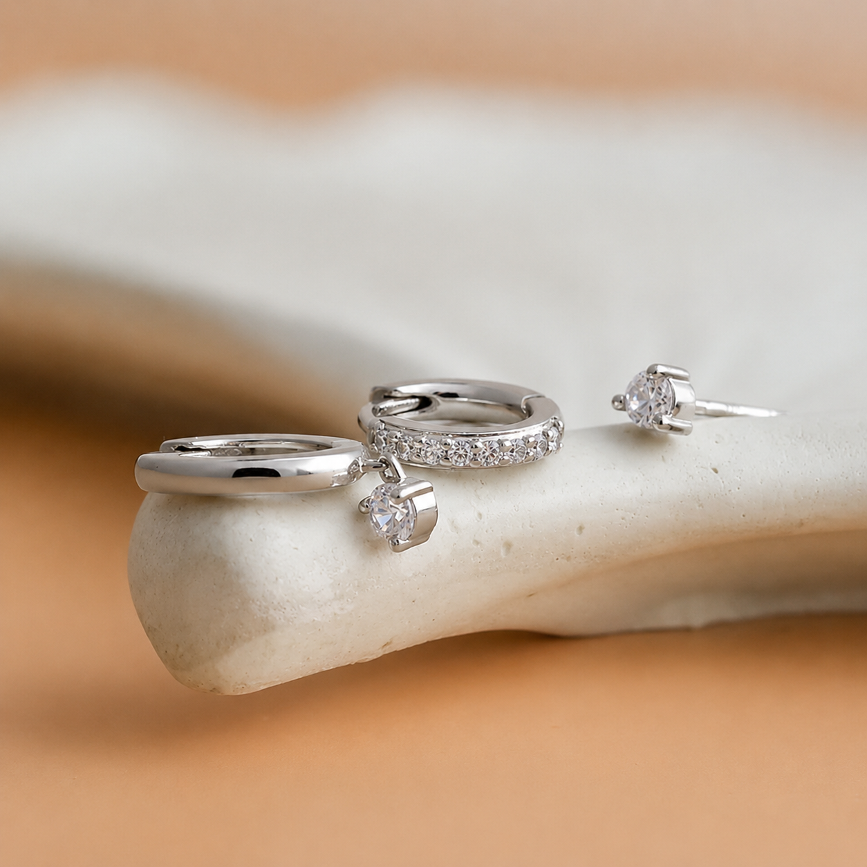 Silver rings with gemstones on a marble surface