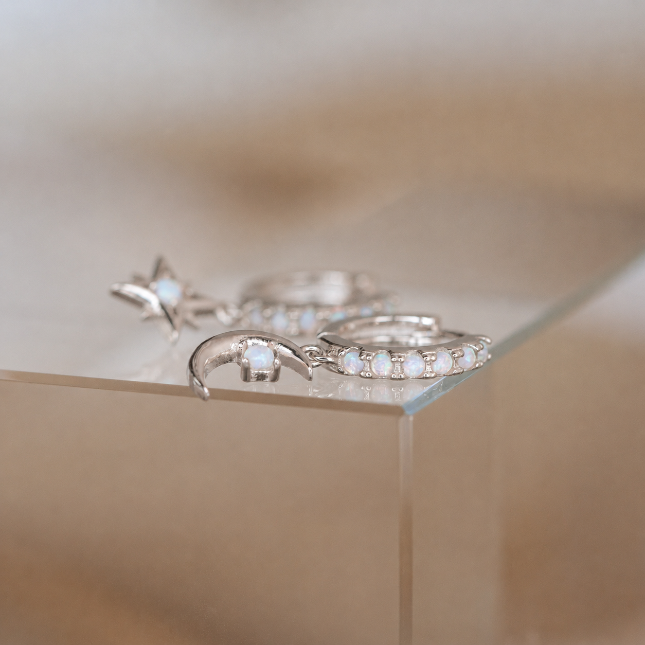 Silver rings with gemstones on a reflective surface