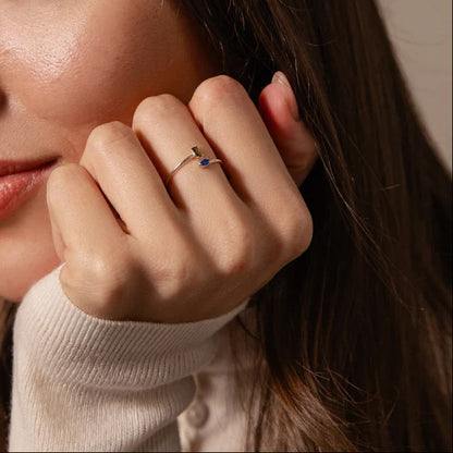 Close-up of a woman applying makeup to her face with a neutral background