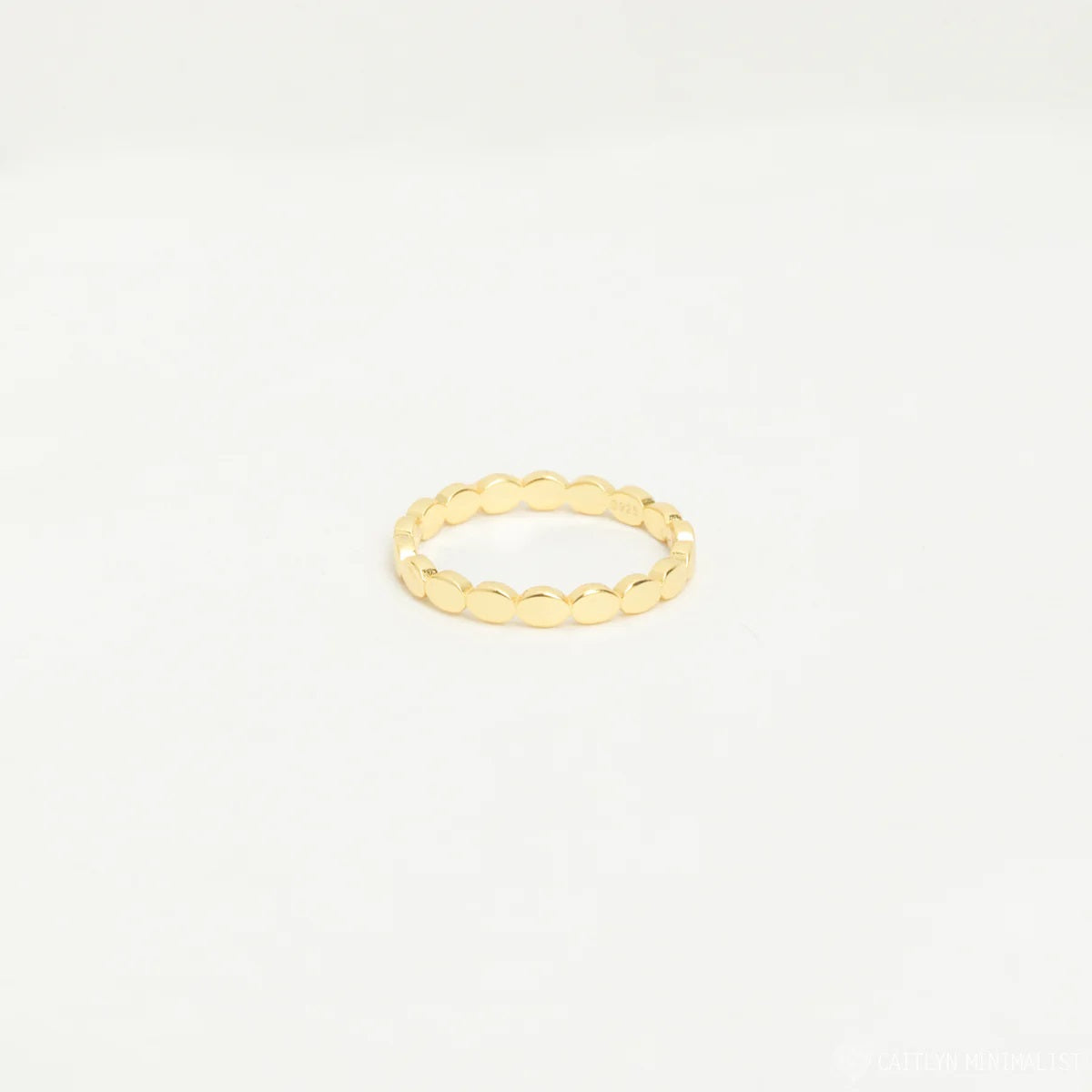 Gold ring on a light beige background