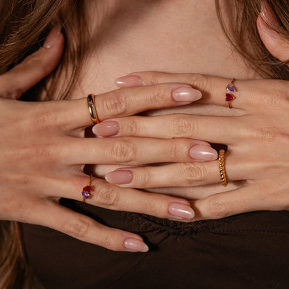 Close-up of hands with rings on fingers, covering face