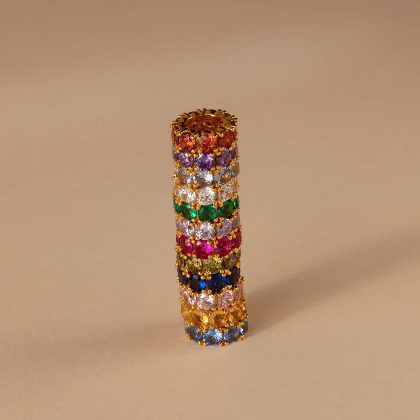 Multicolored gemstone ring on a beige background