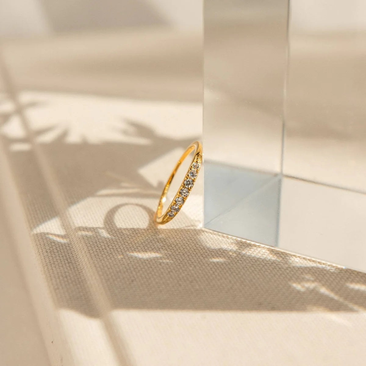 Gold ring with small stones on a textured surface