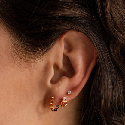 Close-up of Luna Amethyst Hoops featuring radiant purple stones