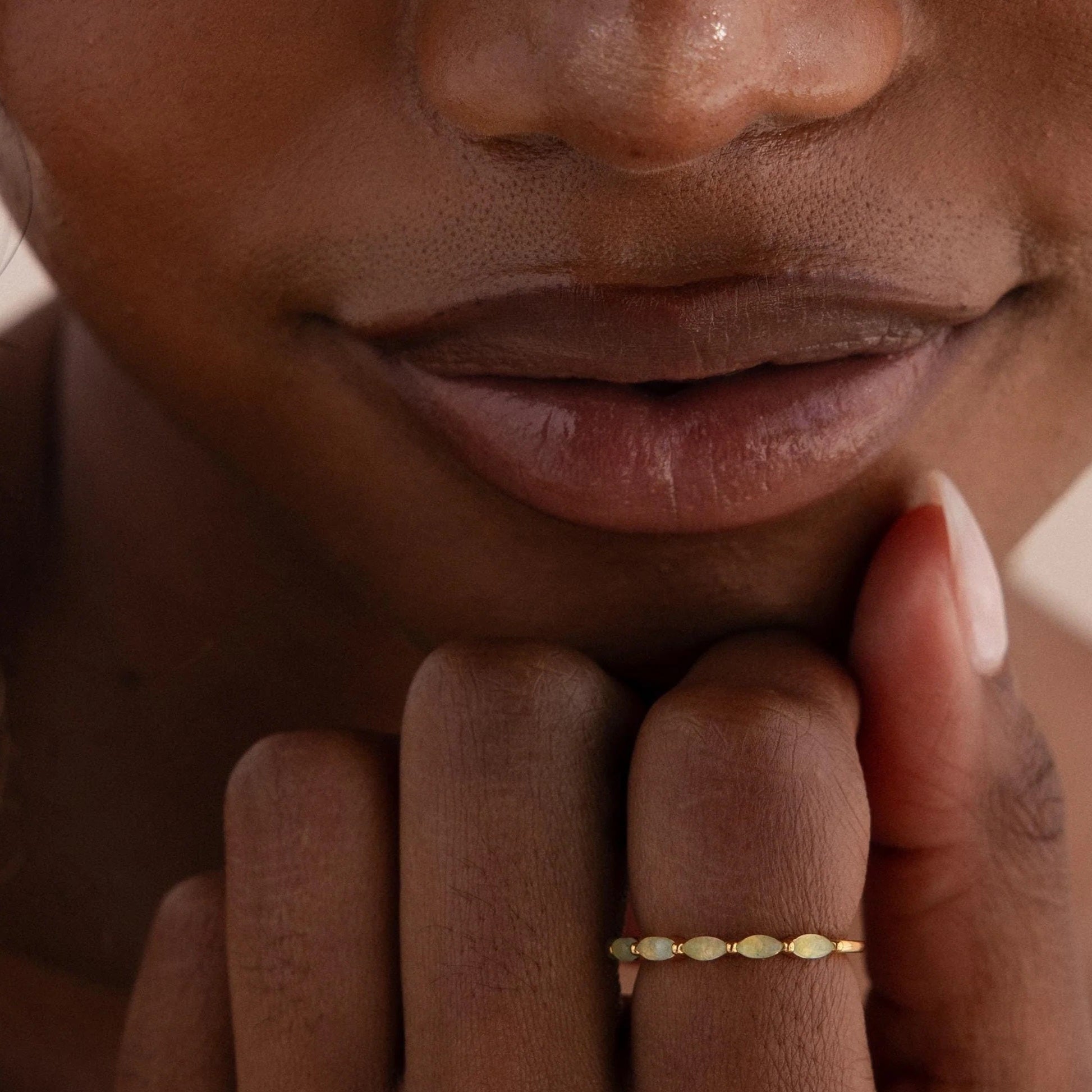 Close-up of a person wearing a gold ring on their finger