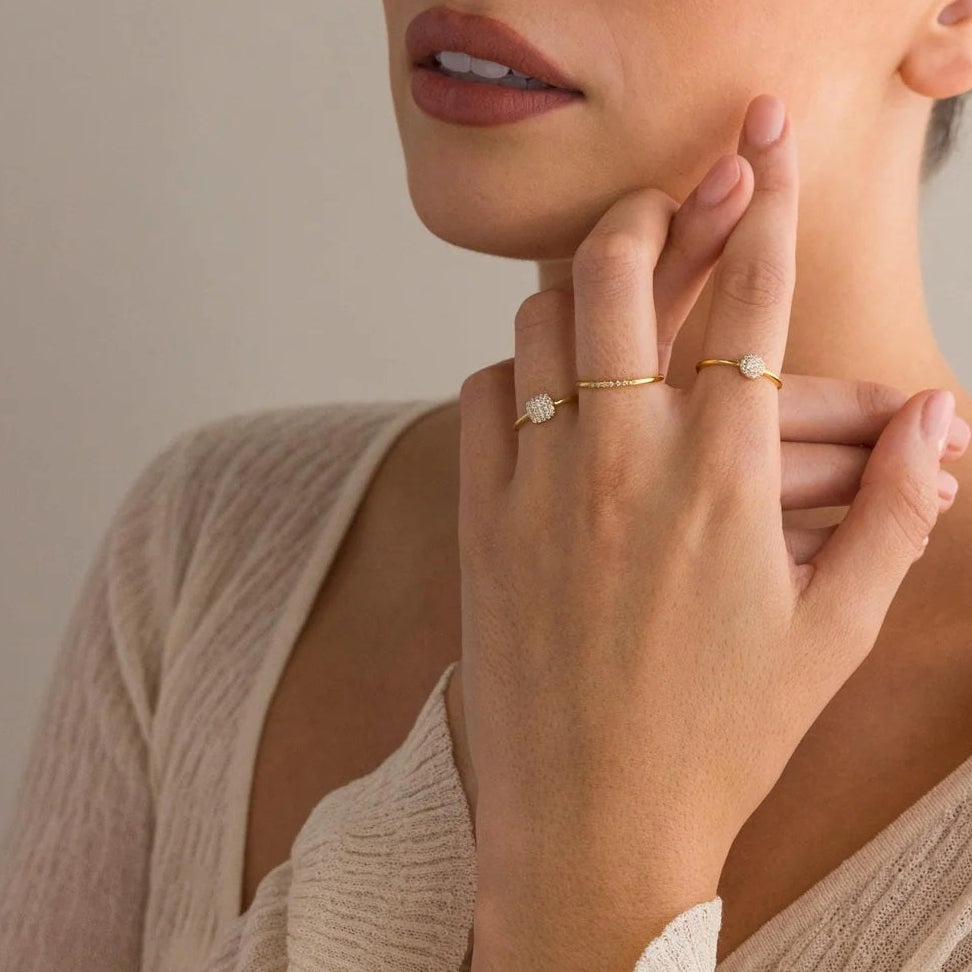 Woman touching her face with a neutral background