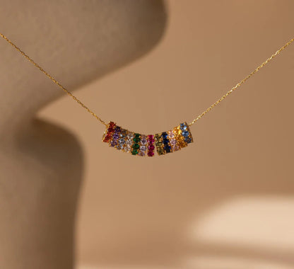 Necklace with colorful gemstones on a beige background