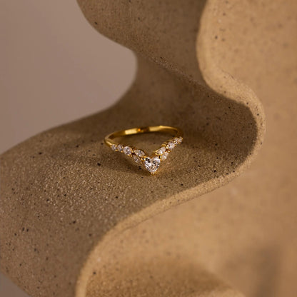 Gold ring with diamonds on a textured brown surface