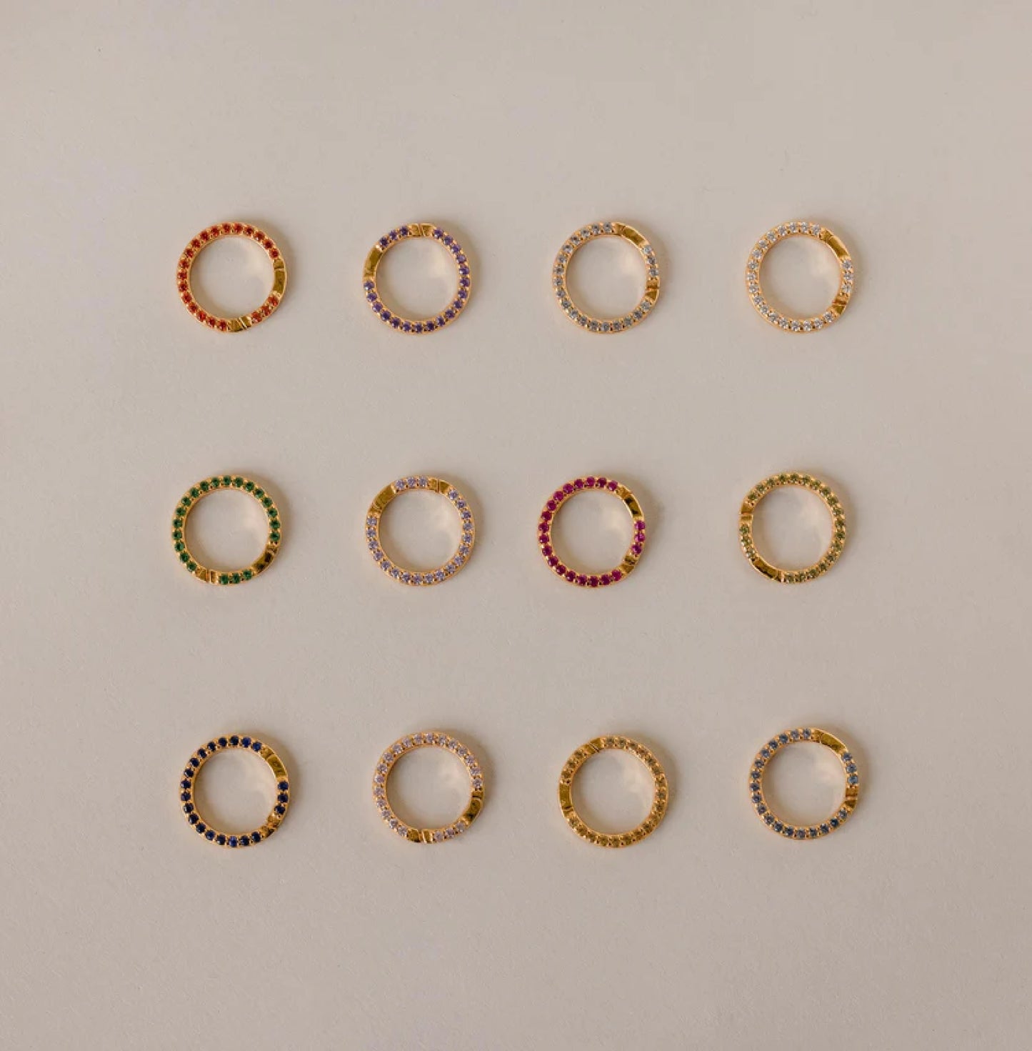 Set of multicolored hoop earrings on a light gray background
