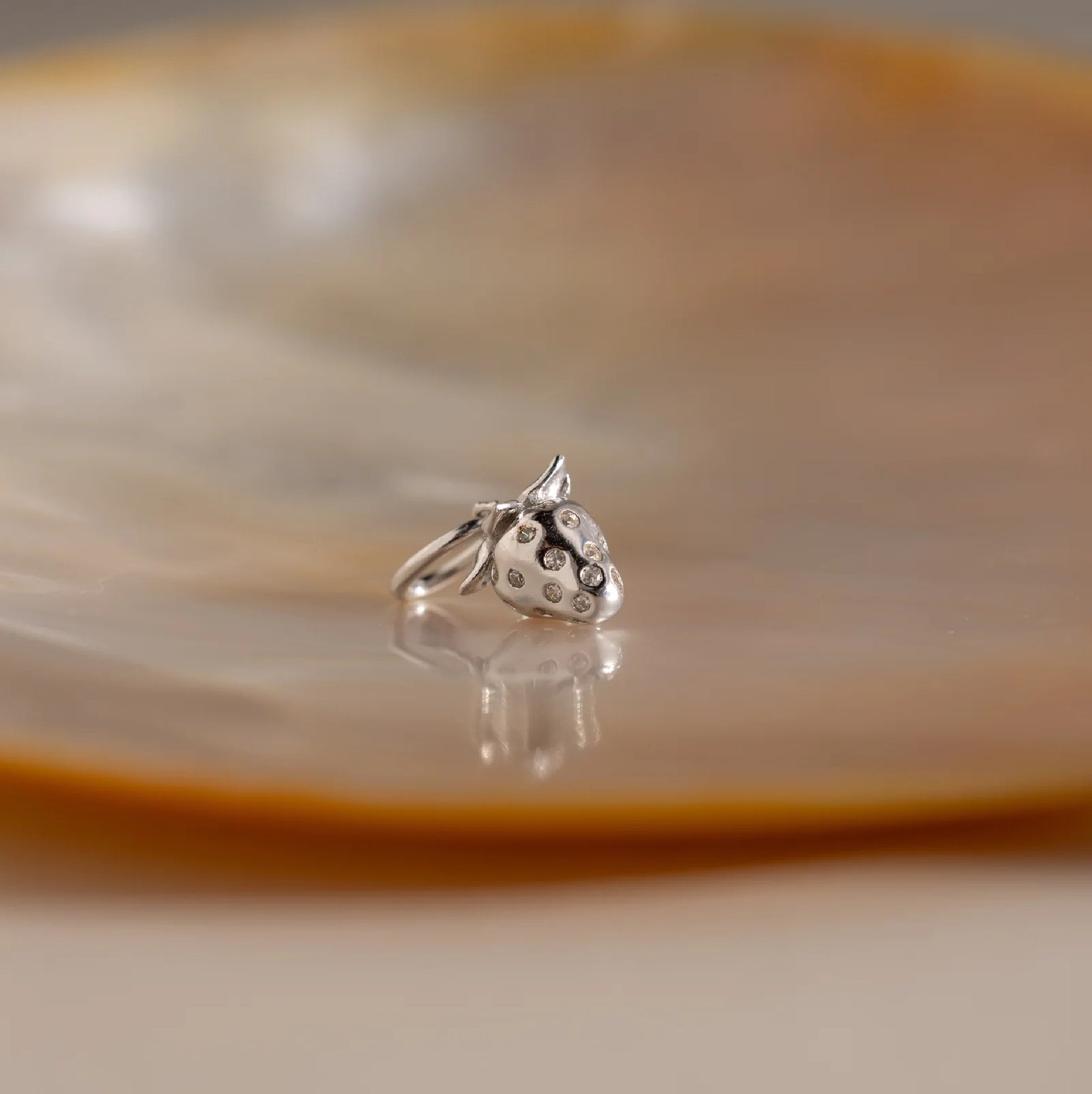 Silver ring with a unique design on a reflective surface