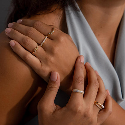 Close-up of hands with jewelry on a neutral background