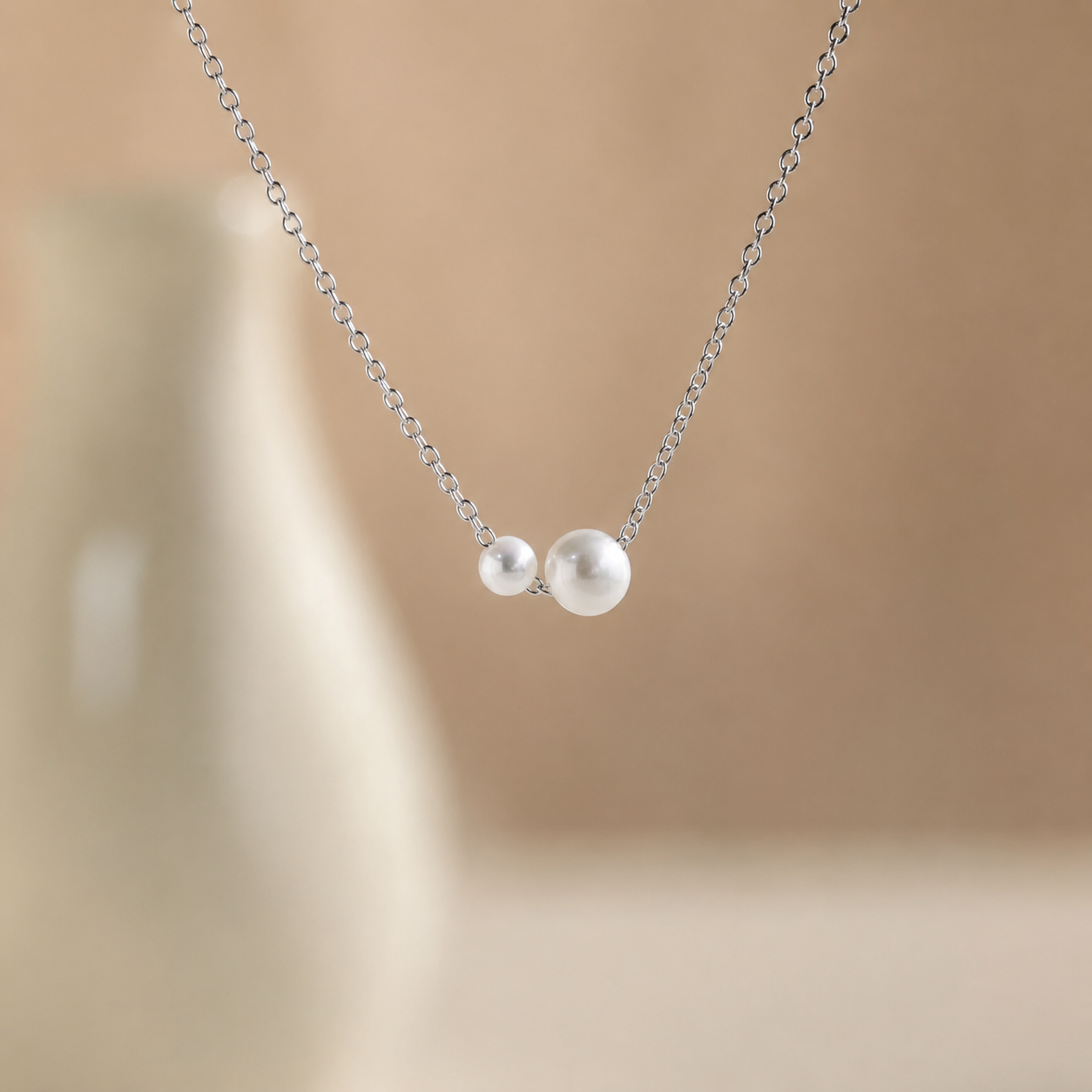 Pearl necklace on a beige background
