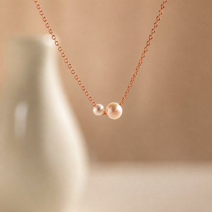 Necklace with two pearls on a beige background