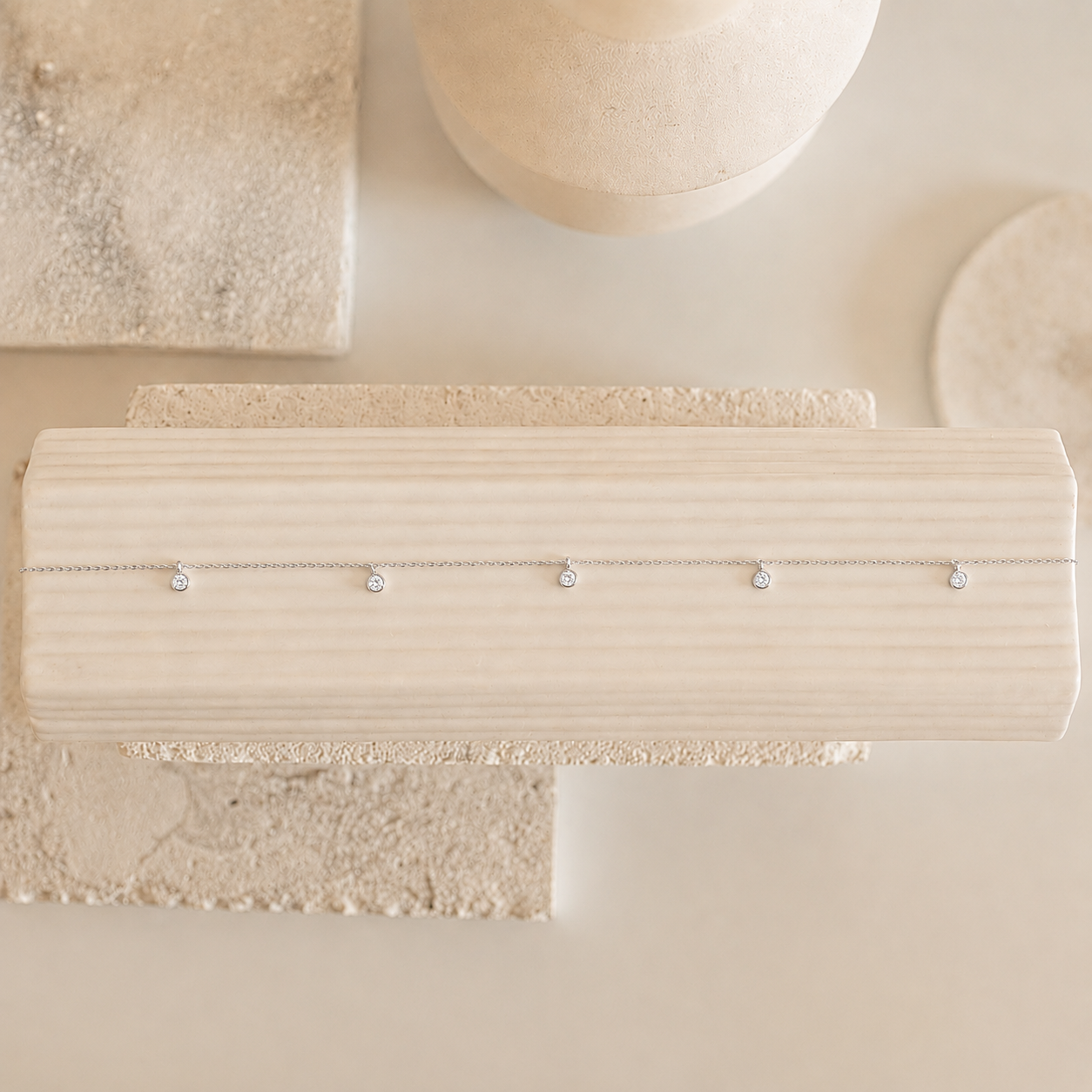 Beige jewelry holder with earrings on a matching background