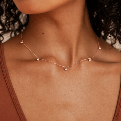 Necklace with small beads on a person's neck