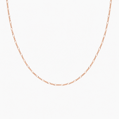 Rose gold chain necklace on a light gray background