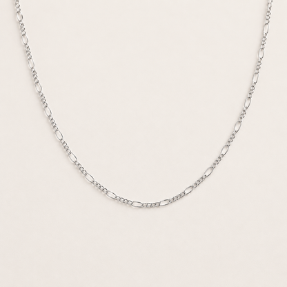 Silver chain necklace on a light gray background