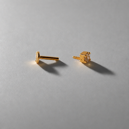 Pair of gold earrings on a gray background