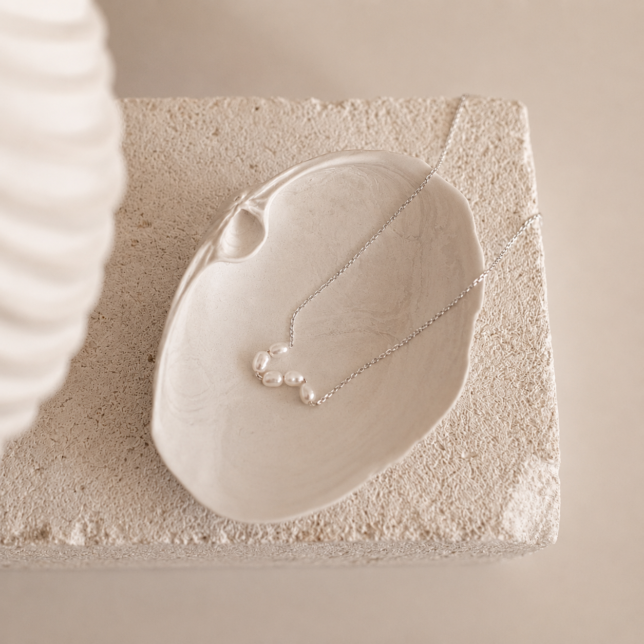Pearl necklace on a stone surface with a soft background