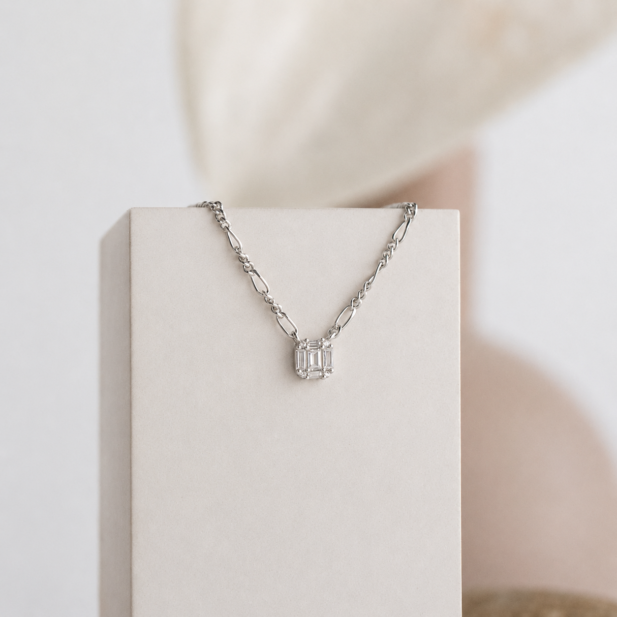 Silver necklace with a pendant on a white box