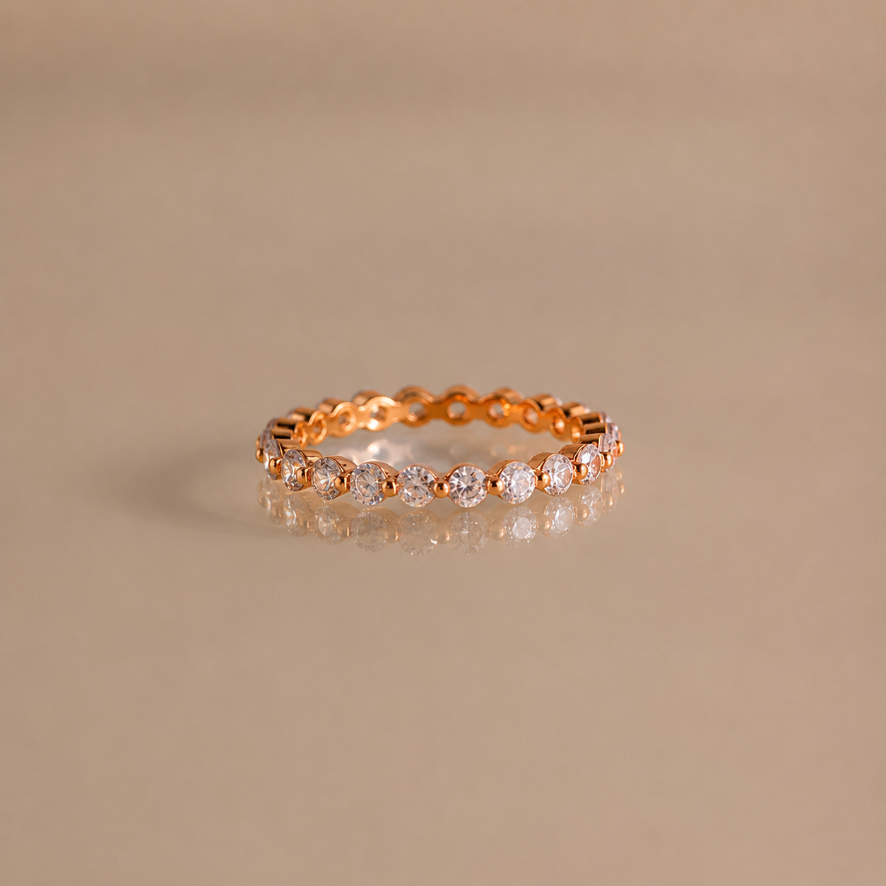 Gold ring with diamonds on a beige background