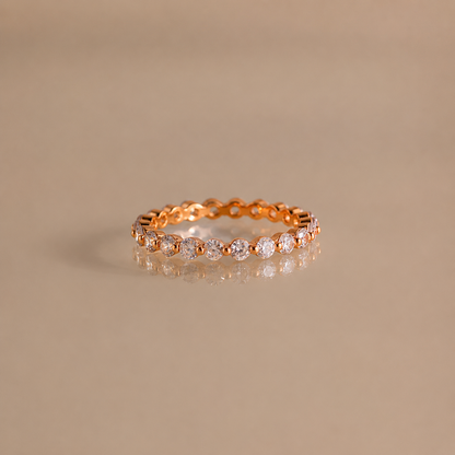 Gold ring with diamonds on a beige background
