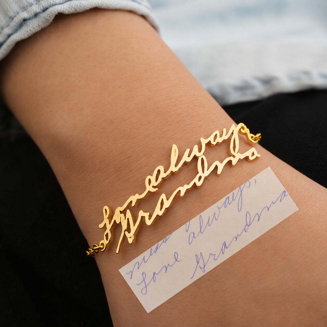 Gold bracelet with 'always' text on wrist next to handwritten note
