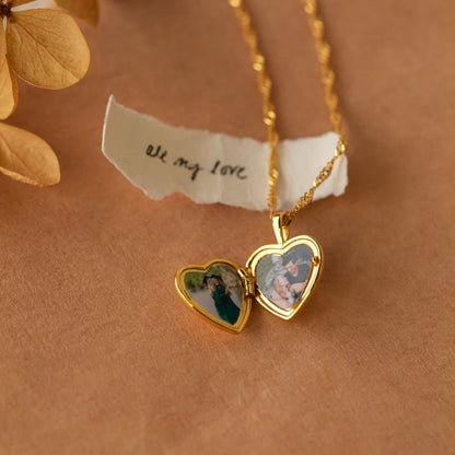 Gold heart-shaped locket with photos on a brown background with 'all my love' note.