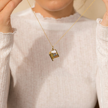Locket pendant with pearl detail.