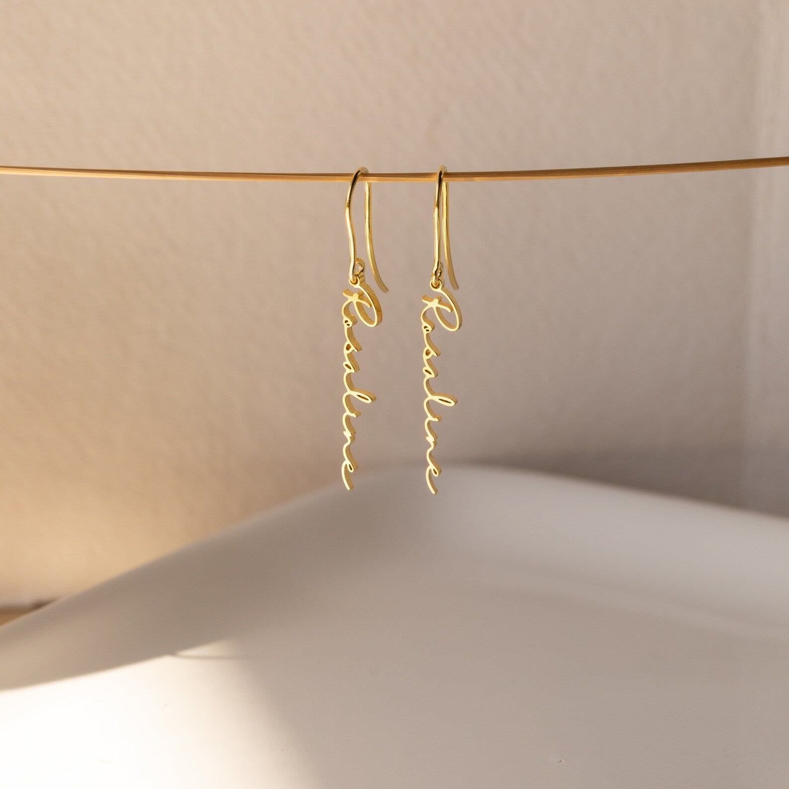 Personalized name earrings in sterling silver, 18K gold, or rose gold, featuring custom name or text in a elegant font