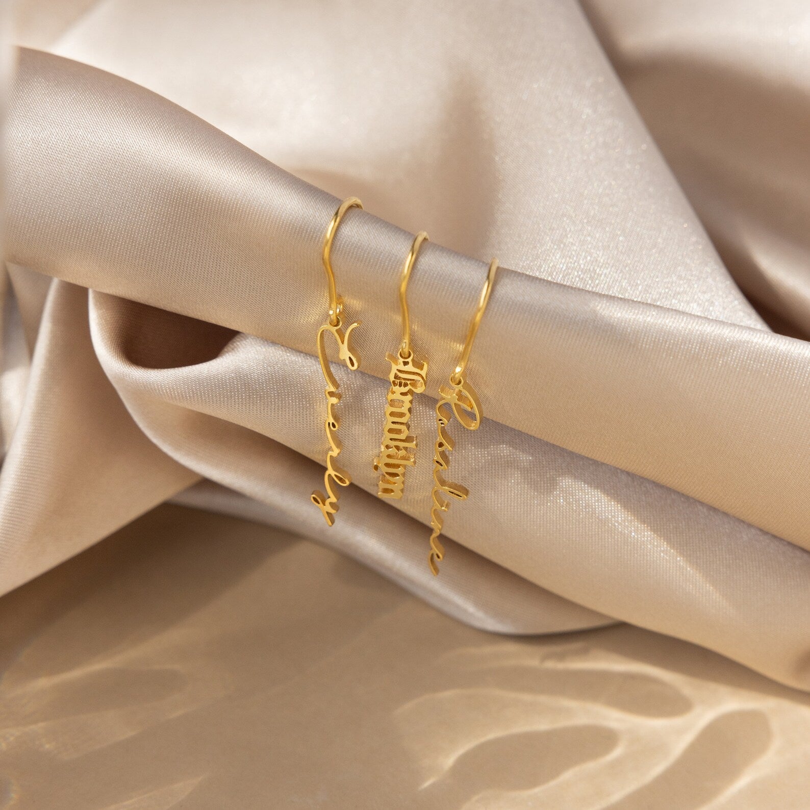 Personalized name earrings in sterling silver, 18K gold, or rose gold, featuring custom name or text in a elegant font