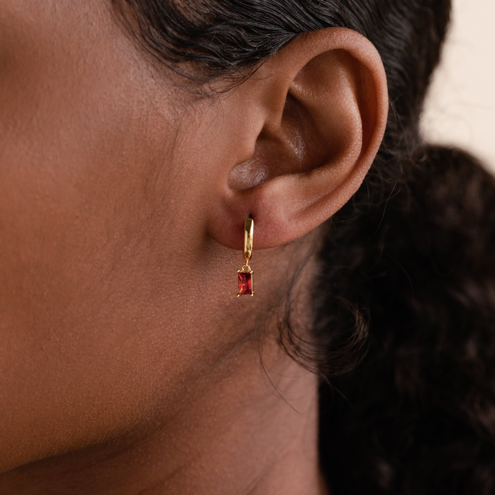 Subtle Birthstone Sparkle: Baguette Birthstone Huggie Hoops 18K Gold January Garnet