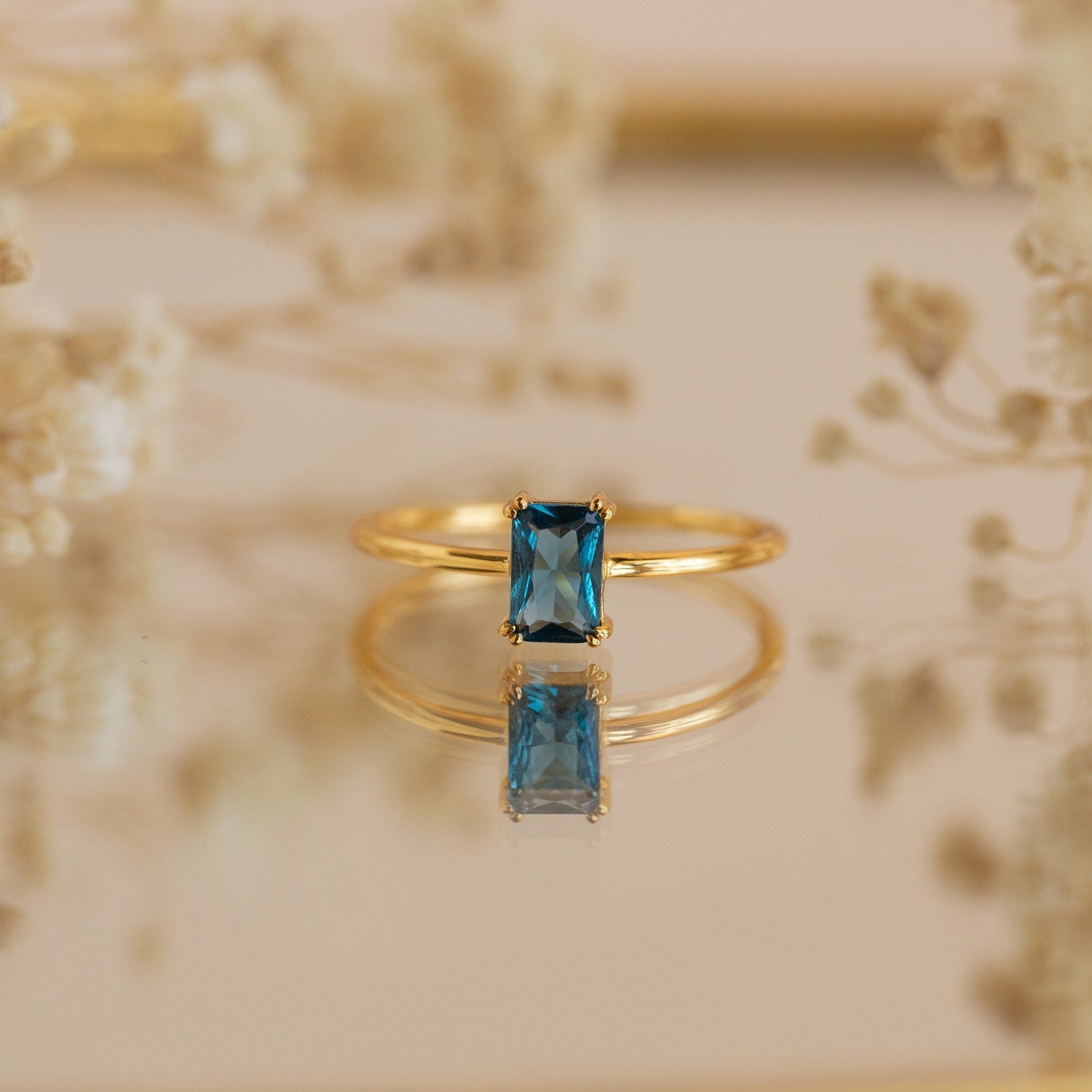 Embrace Vintage Elegance with the Blue Topaz Emerald Ring