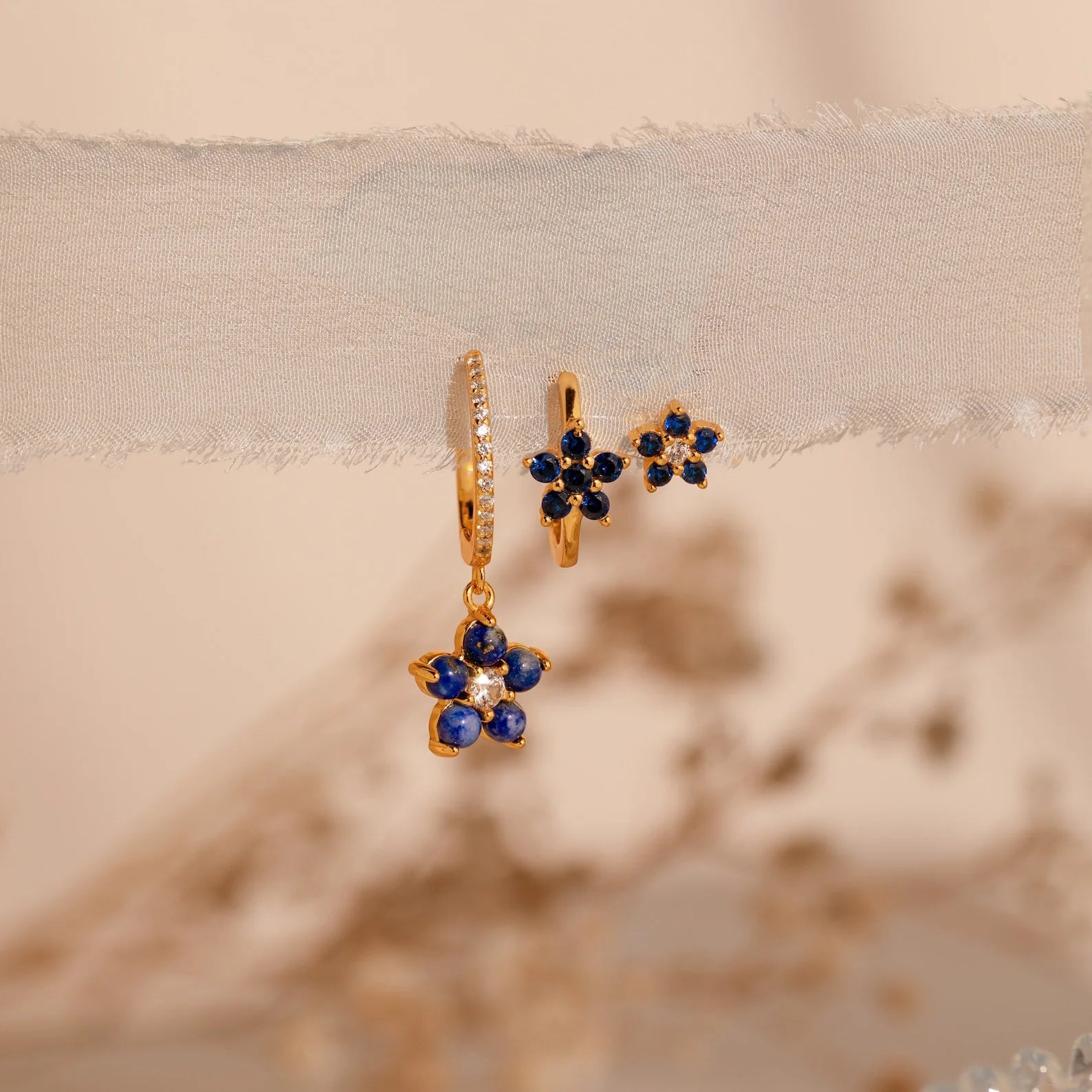 Floral sapphire earrings set with sparkling blue stones