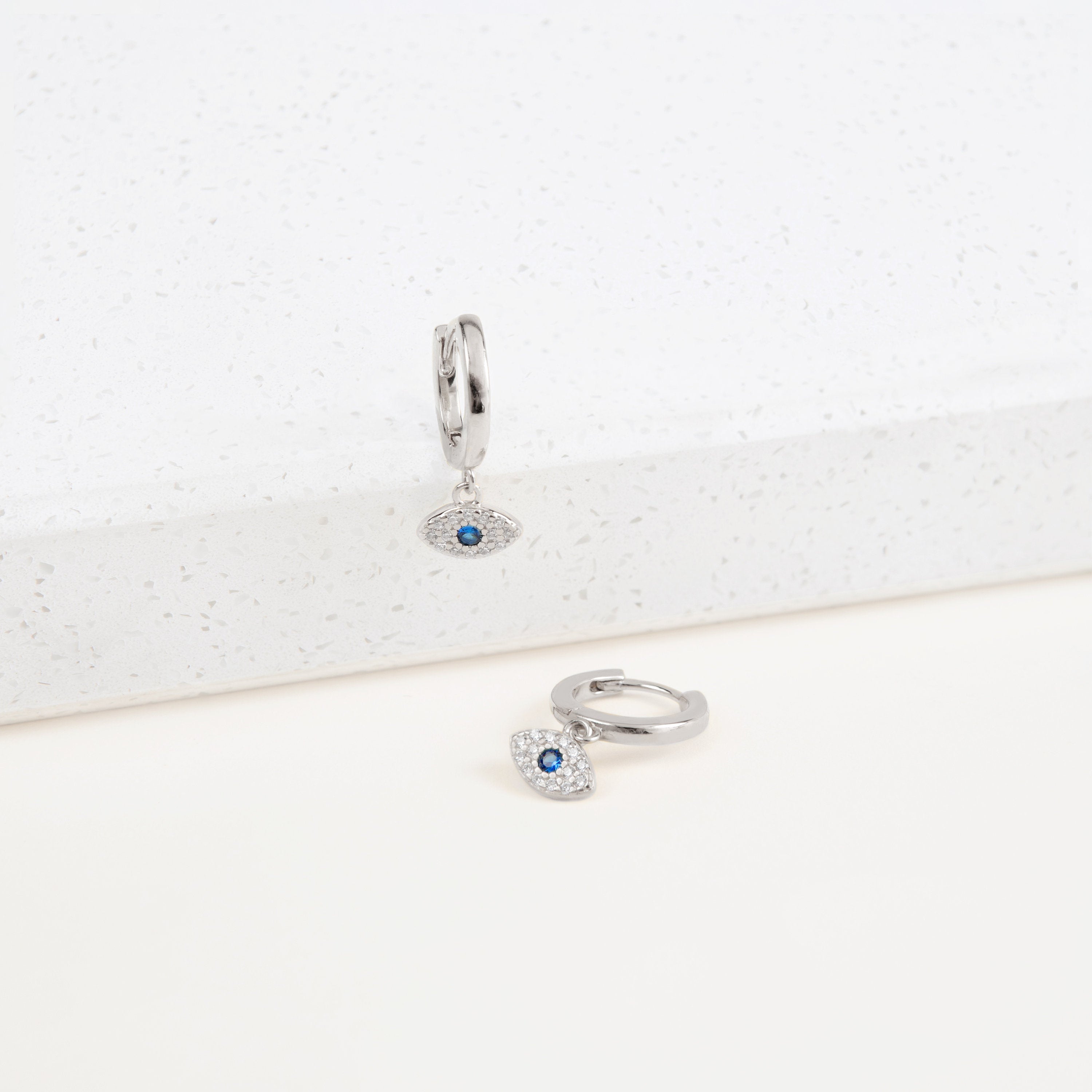 Iris Huggie With Sterling Silver Plated.