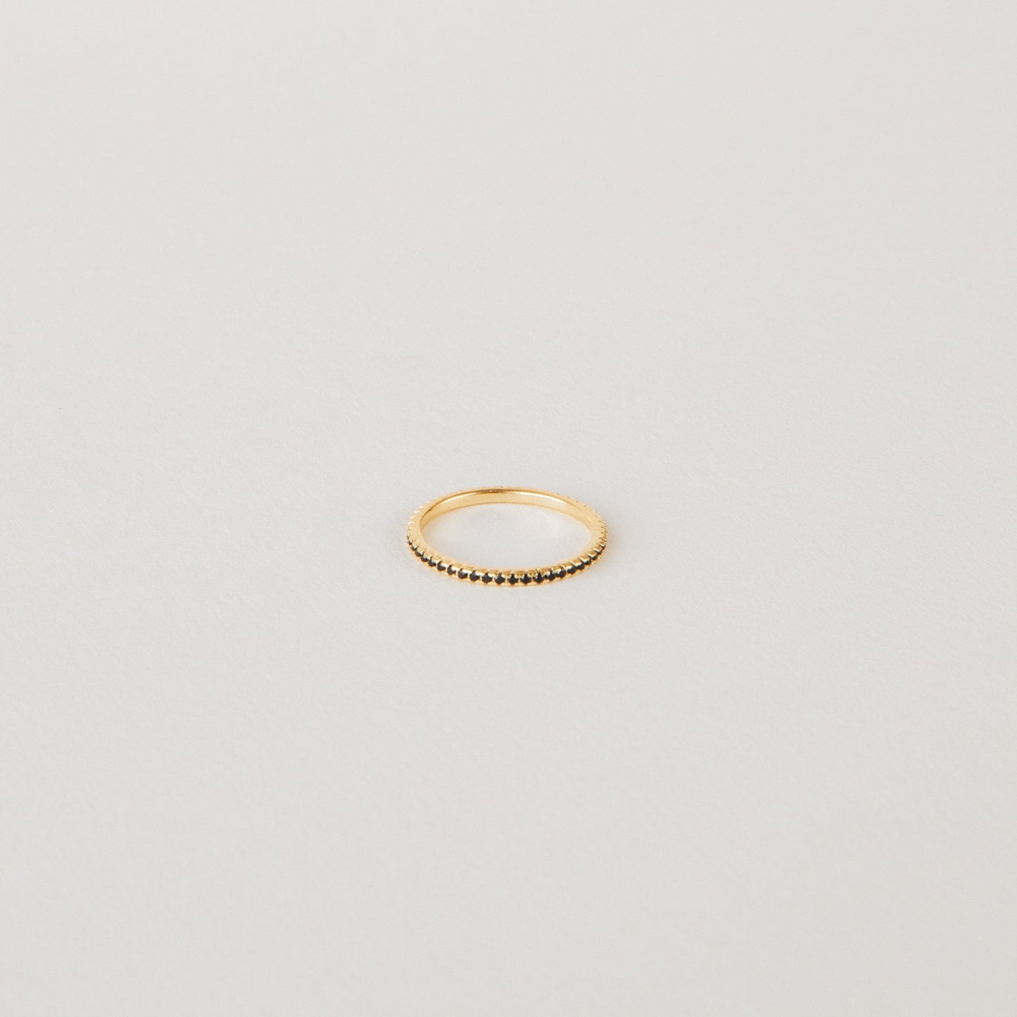Amber Eternity Ring featuring CZ black diamonds on a sterling silver or 18K gold band, perfect for everyday wear or as a statement piece