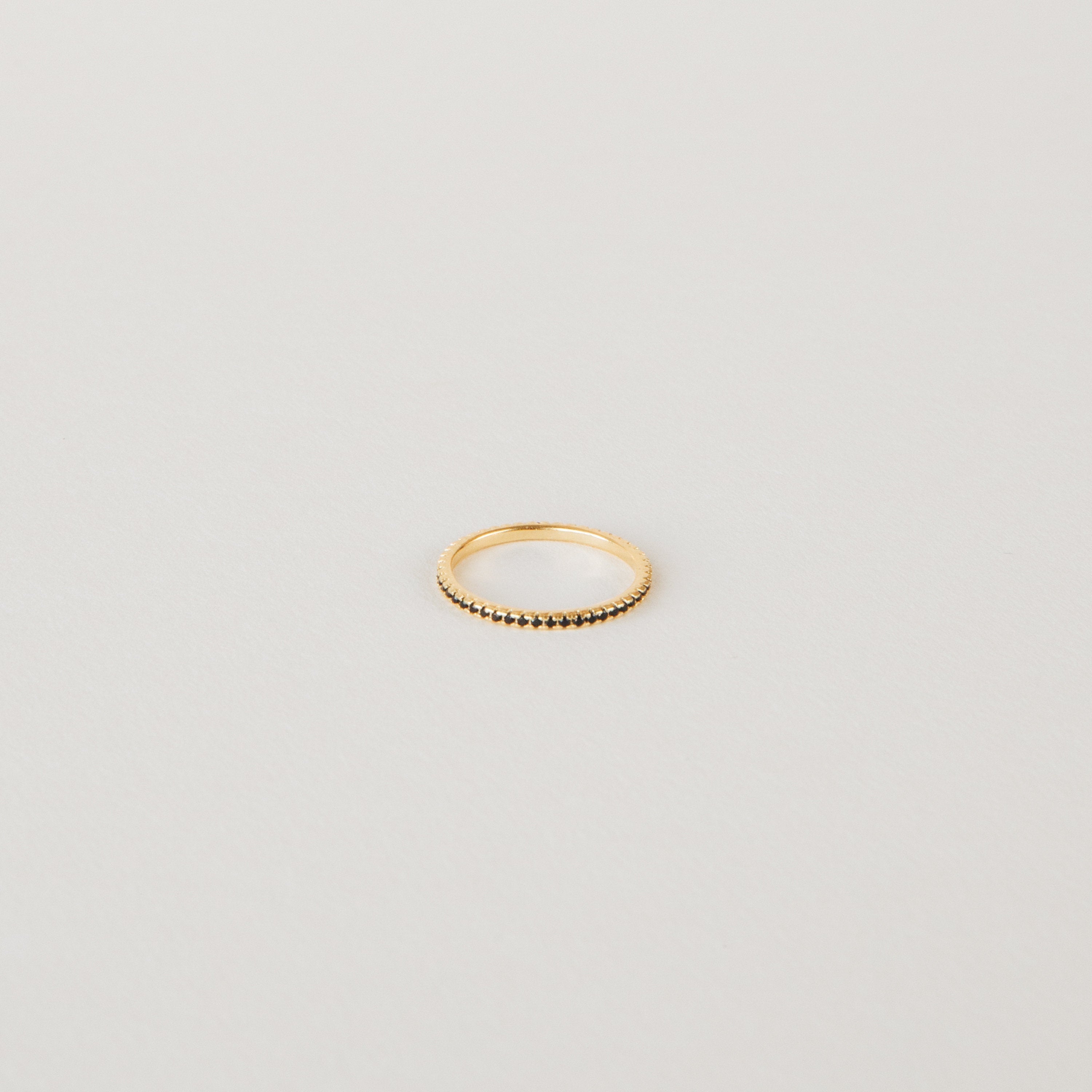 Amber Eternity Ring featuring CZ black diamonds on a sterling silver or 18K gold band, perfect for everyday wear or as a statement piece
