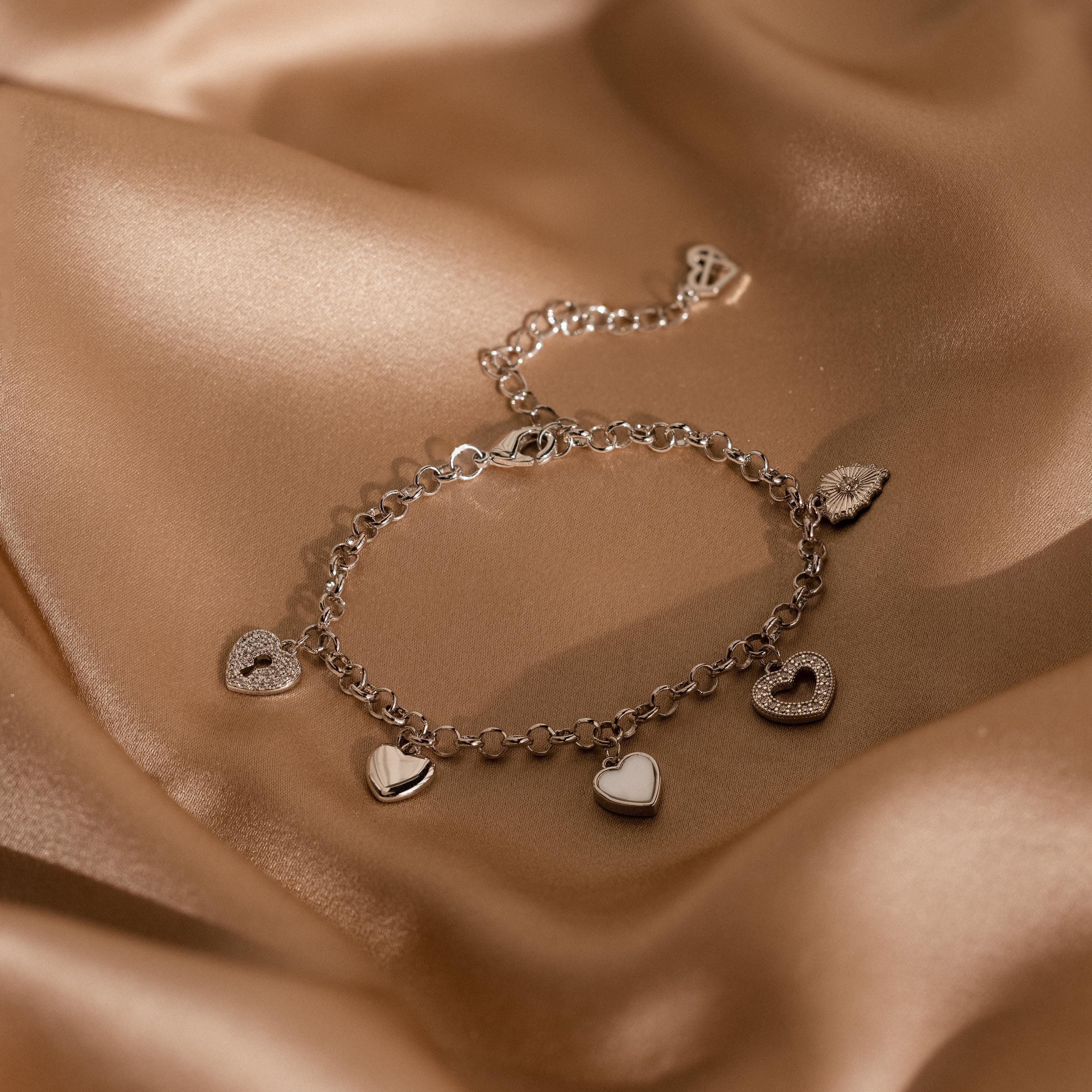Wear Your Heart charm bracelet with dainty linked hearts on a minimalist chain.